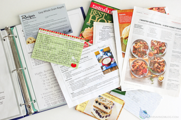 Photo of a recipe binder with a pile of disorganized recipes on top. It's time to clean this clutter up!