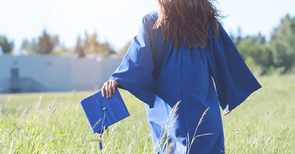 graduate holding paper hat