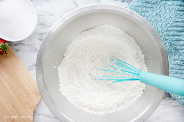 easy strawberry muffins start with a mixing bowl and a whisk!