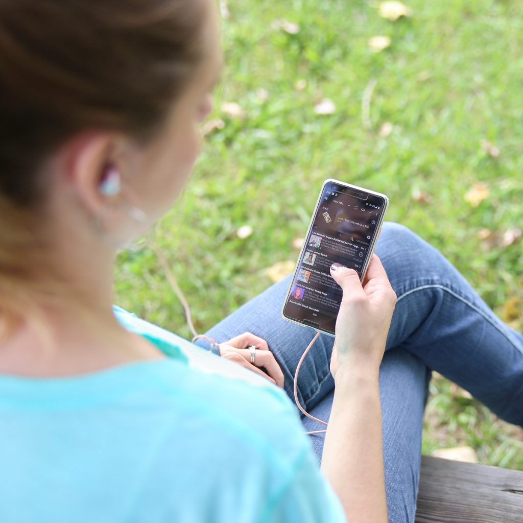 woman listening to music on her phone