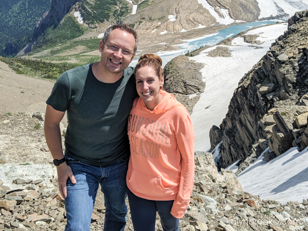 couple smiling in front of a scenic view